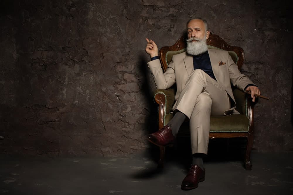 An old man wearing elegant pants.