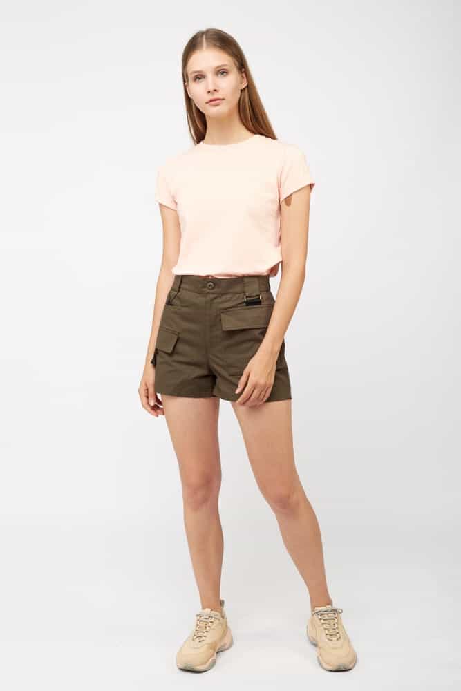 A woman wearing a T-shirt with her loose fit shorts.