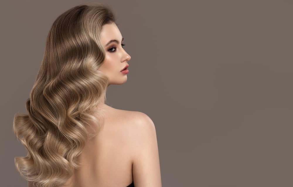 A woman wearing a long and wavy wig.
