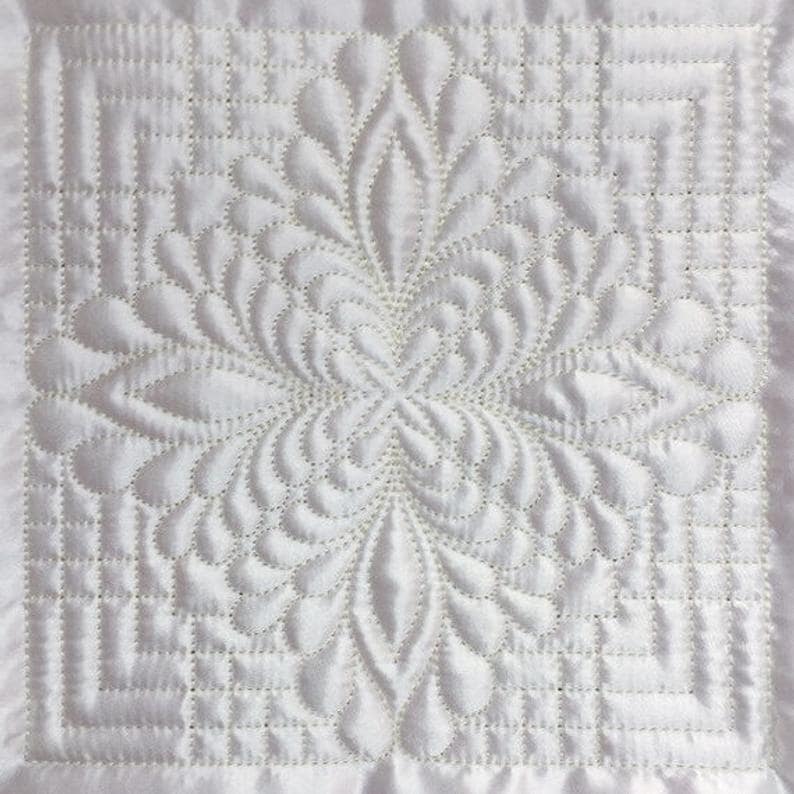 A Trapunto feather quilt from Etsy.