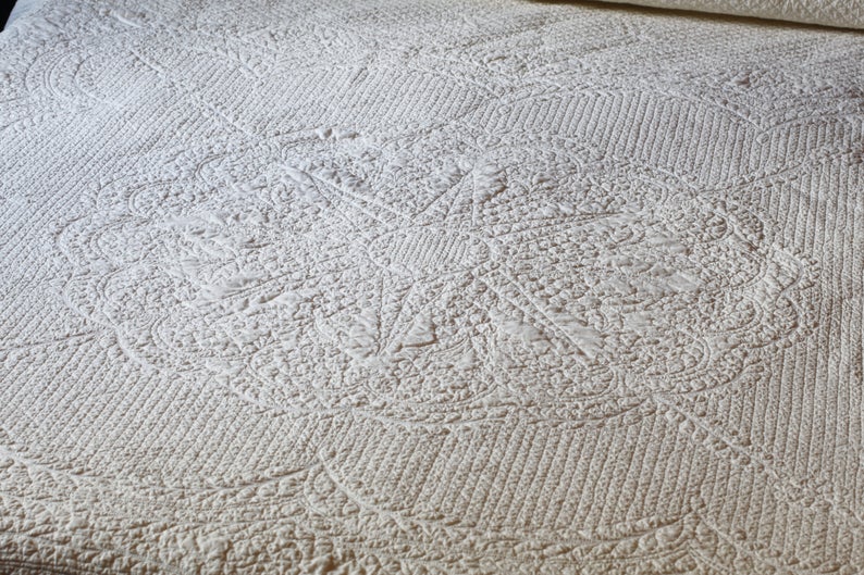 A traditional whole cloth quilt from Etsy.