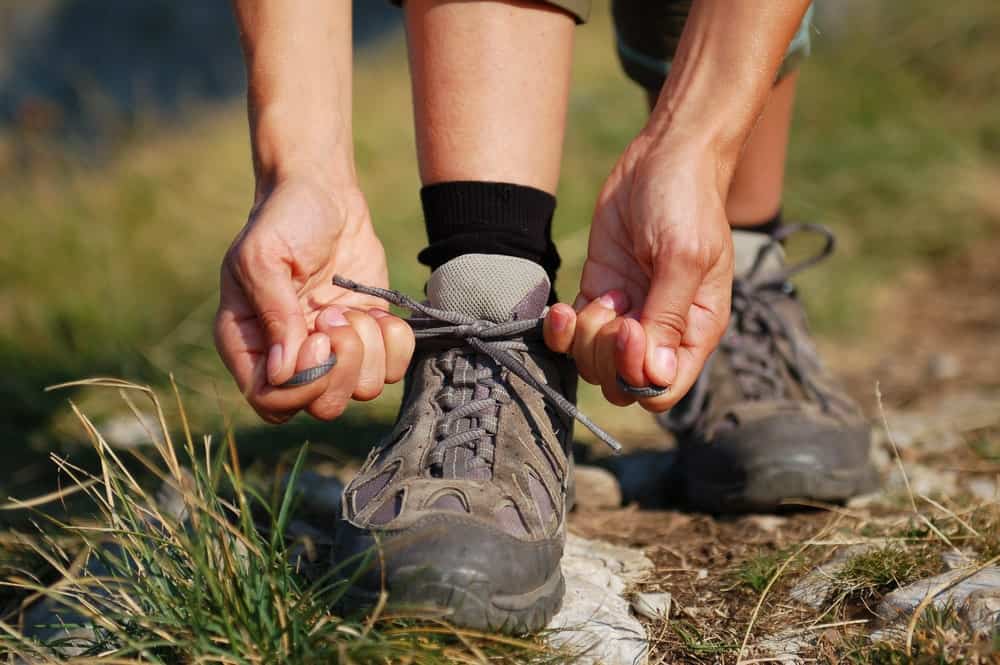 A woman lacing her day hiking boots.