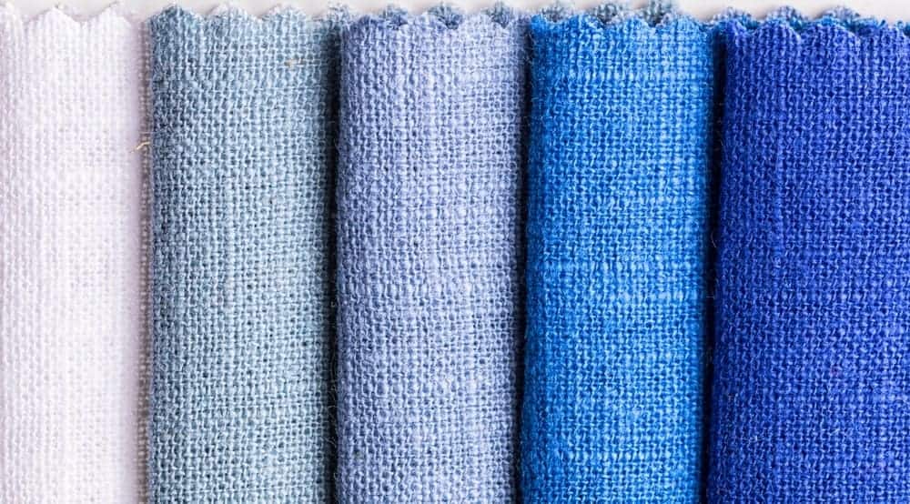 A close look at a row of colorful cloths for quilting.
