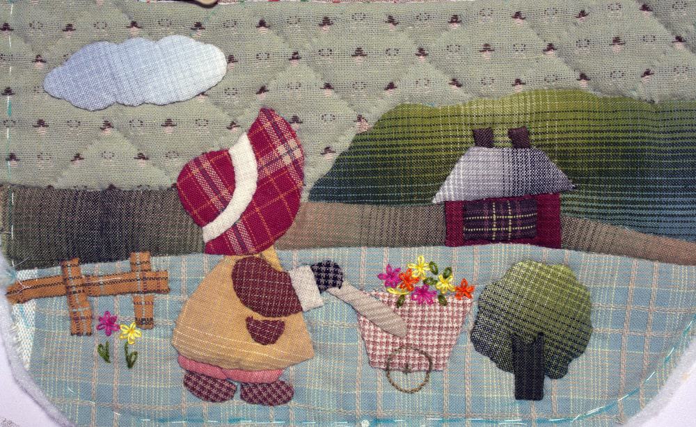 A close look at a colorful applique quilt.