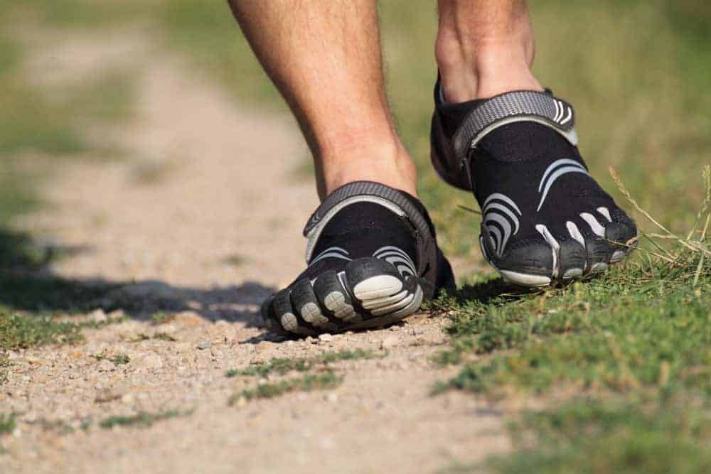 This is a close look at a man wearing a pair of toed shoes.