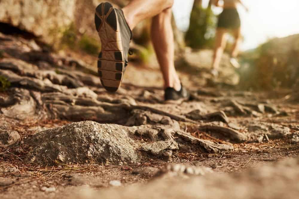 A close look at a woman wearing trail running shoes.
