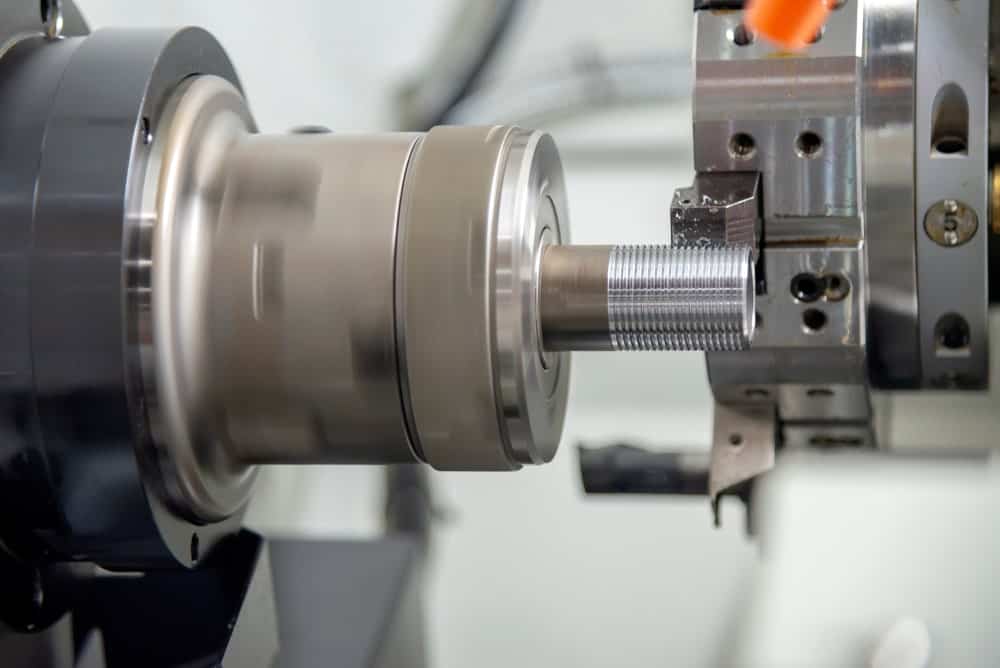 Acme thread being manufactured with a machine.