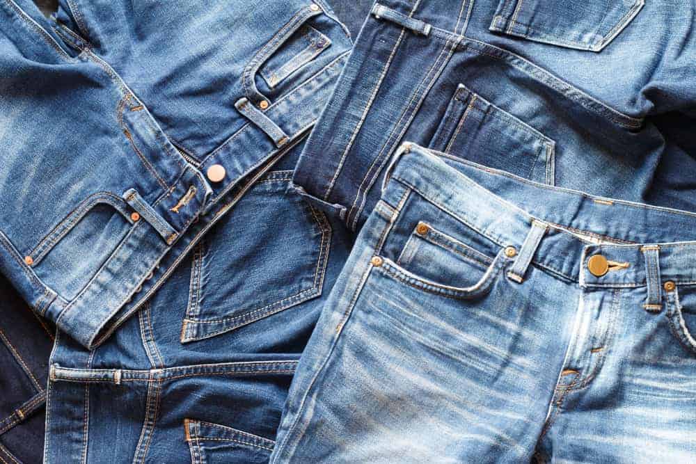 A pile of denim pants.