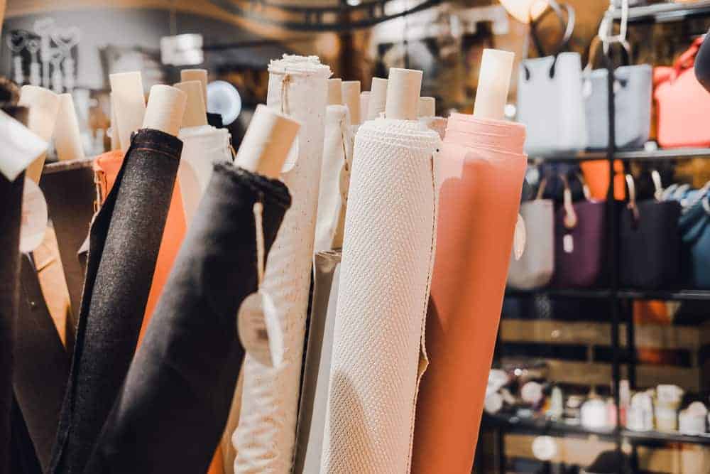 Rolls of multicolored fabrics and textiles. 