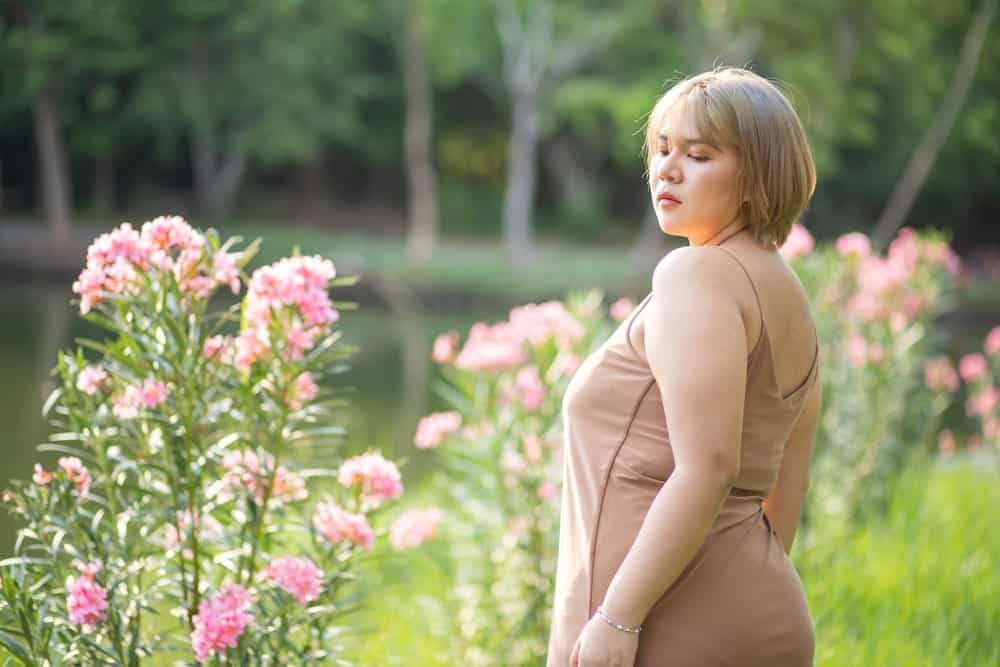 A woman wearing a camisole at the park.