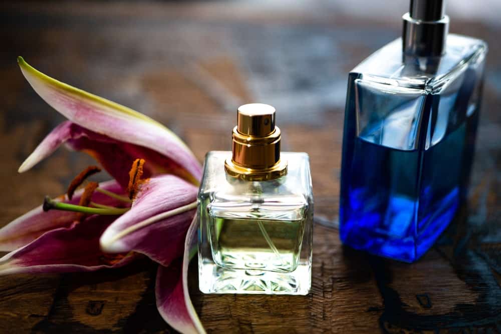 This is a couple of perfume bottles with a Lilly flower.