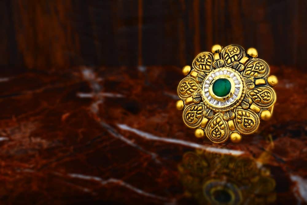 This is a close look at an antique gold ring with minute details.