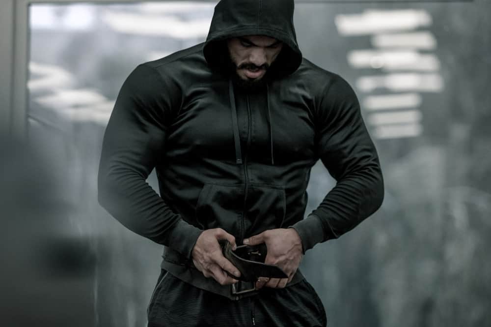 This is a look at man wearing an athletic sweatshirt with a hood.