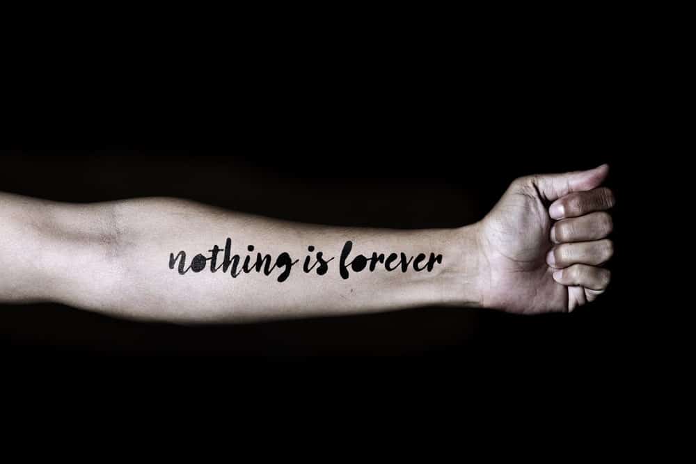 This is a close look at a forearm with an inscription tattoo.