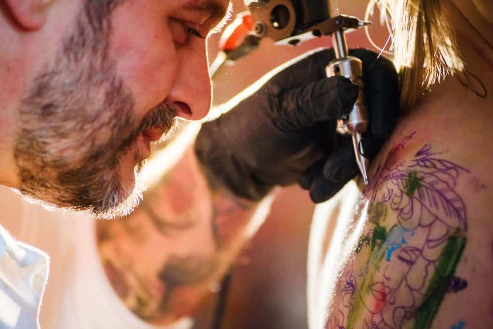 This is a close look at a woman having her back tattooed.