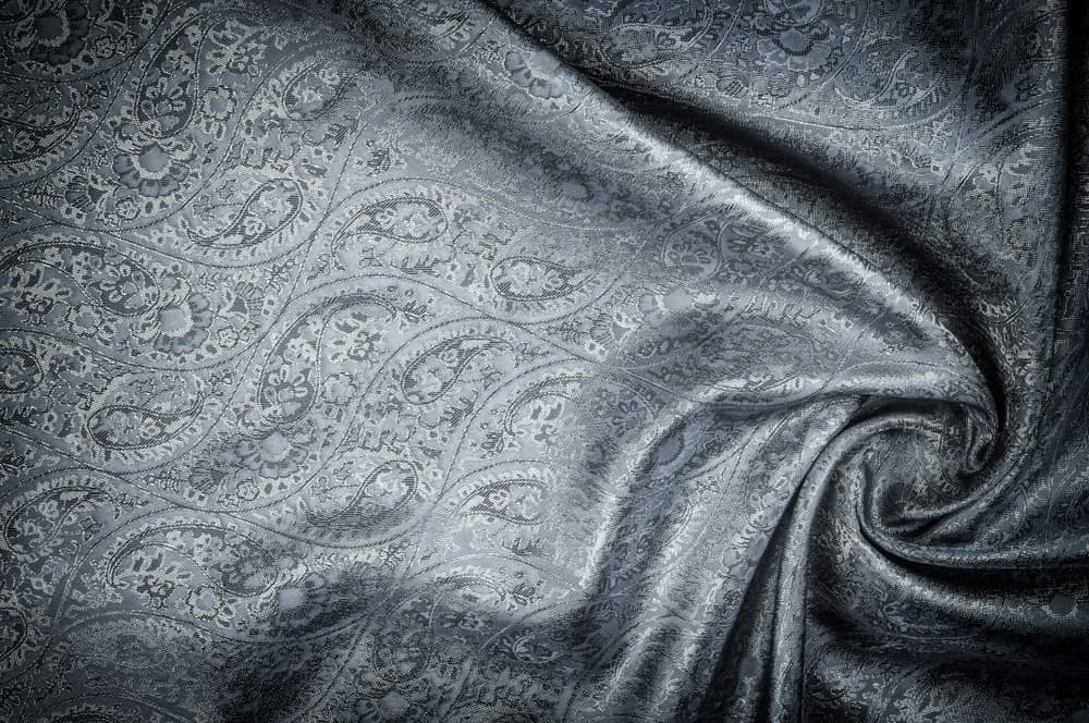 This is a piece of patterned cloth that has Jacquard weave.