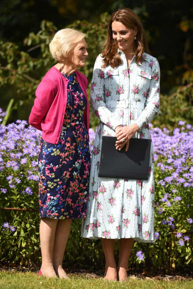 Two women wearing elegant dresses in floral pattern.