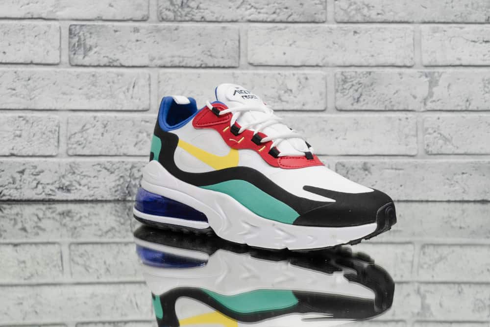 This is a close look at a Nike Air Max 270 React 'Bauhaus' White Trainers Athletic Sneakers on display.