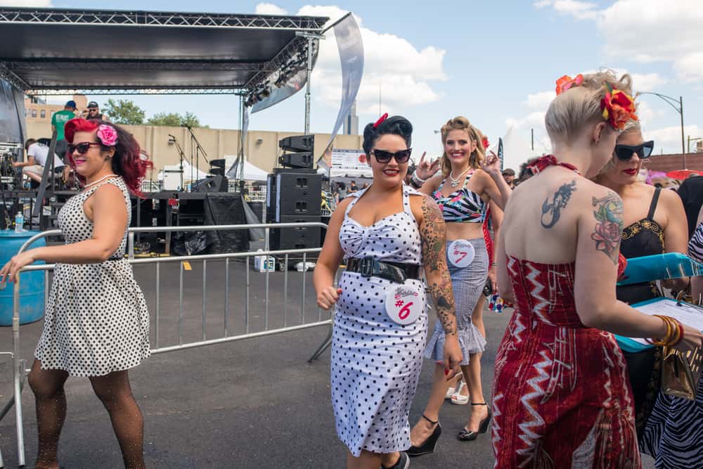 Women dressed in vintage 1950s style wave outfits.