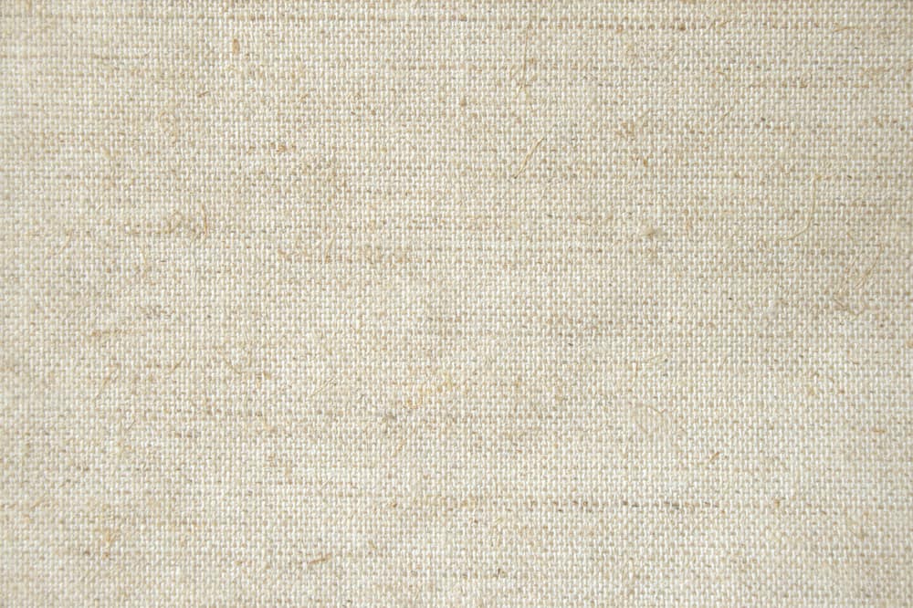 This is a close look at a beige muslin fabric.