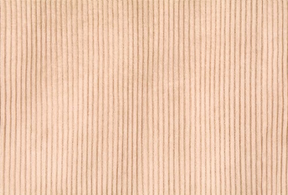 This is a close look at a patterned brown Corduroy fabric.