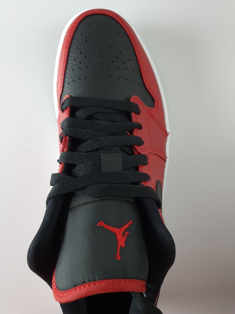 This is a black and red shoe made of nylon fabrics.