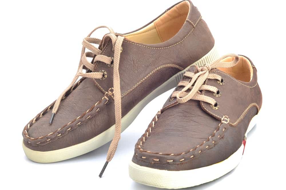 This is a close look at a pair of brown Cowhide shoes.