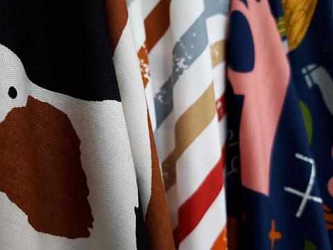 This is a close look at various colorful patterned rayon fabrics on display.