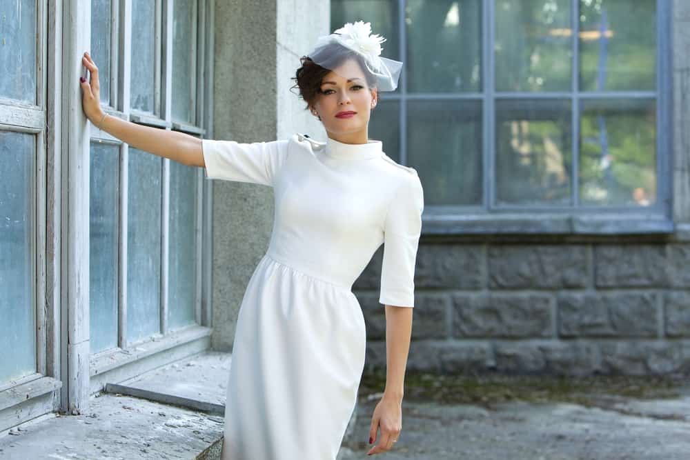 This is a woman wearing a white Sheath Dress.