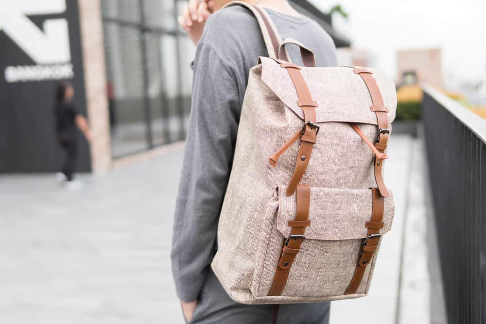 This is a close look at a man carrying a backpack.