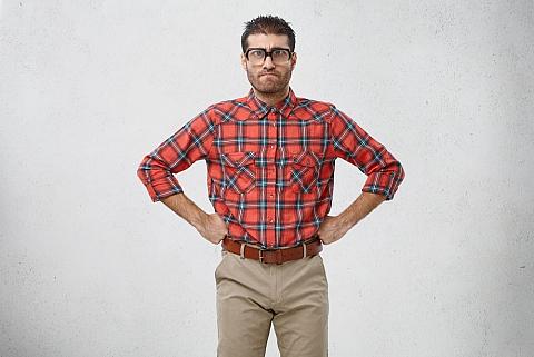 Geek man with his hands on his waist.