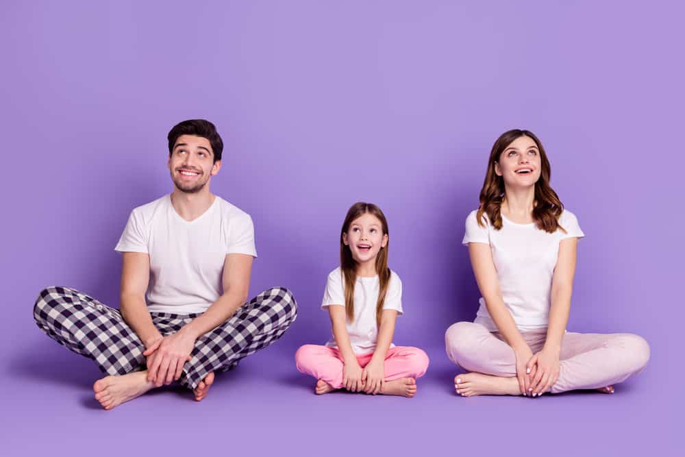 A family wearing pajamas and white shirts.