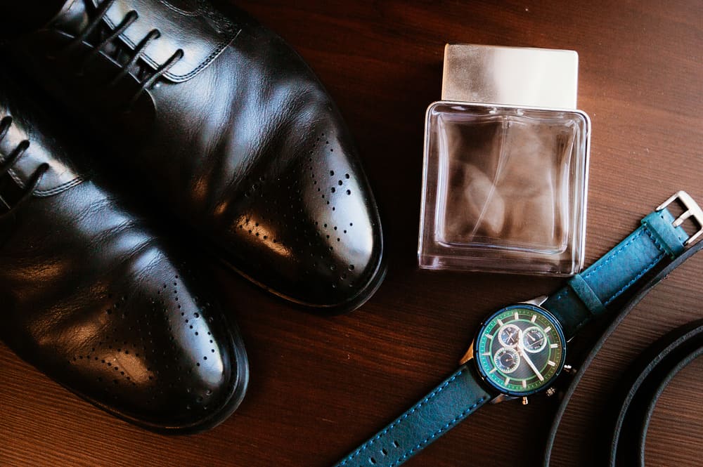 Men's accessories over a wooden table.