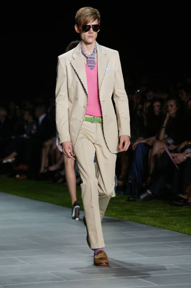 Model in Sloane ranger clothes walks the runway.