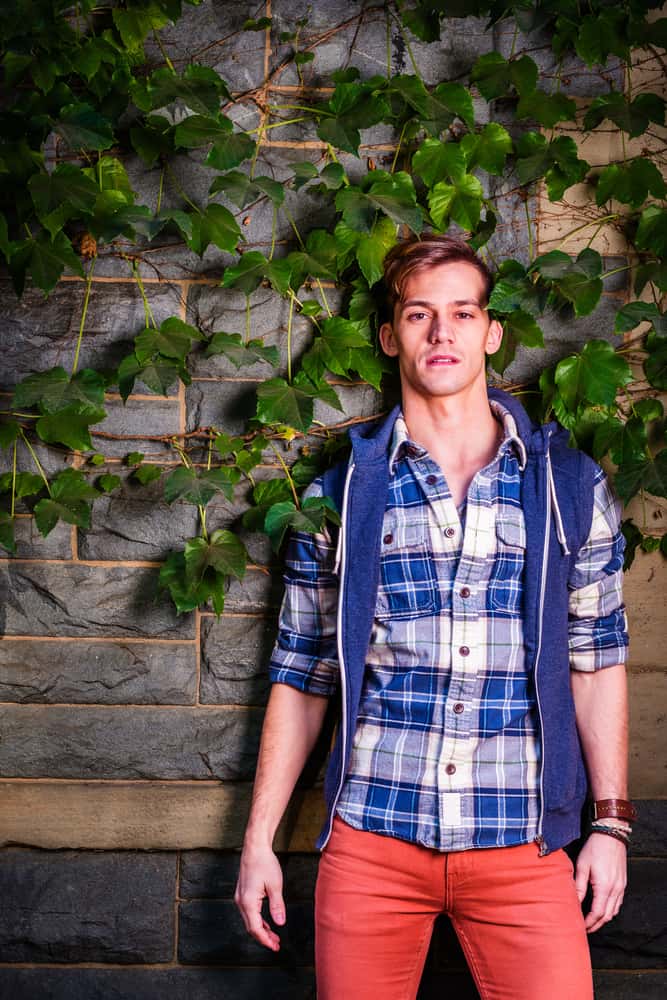 This is a man wearing a pair of red shorts and a blue plaid shirt.