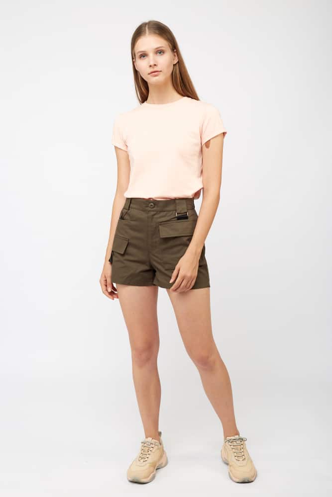 A woman wearing a pair of cargo shorts.