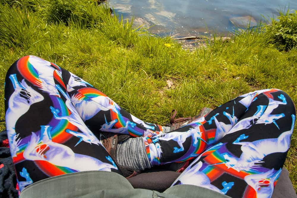 A man on a hike wearing a pair of unicorn print yoga pants.