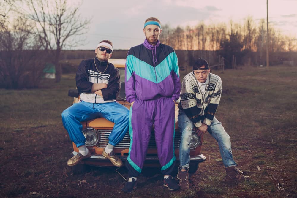 This is a close look at three friends wearing 90s-inspired outfits.
