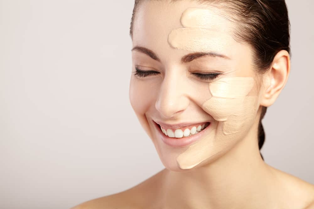 Woman with foundation shades on face.