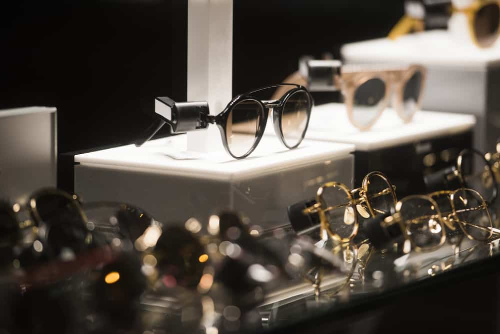 Sunglasses on display at a store with various glasses.
