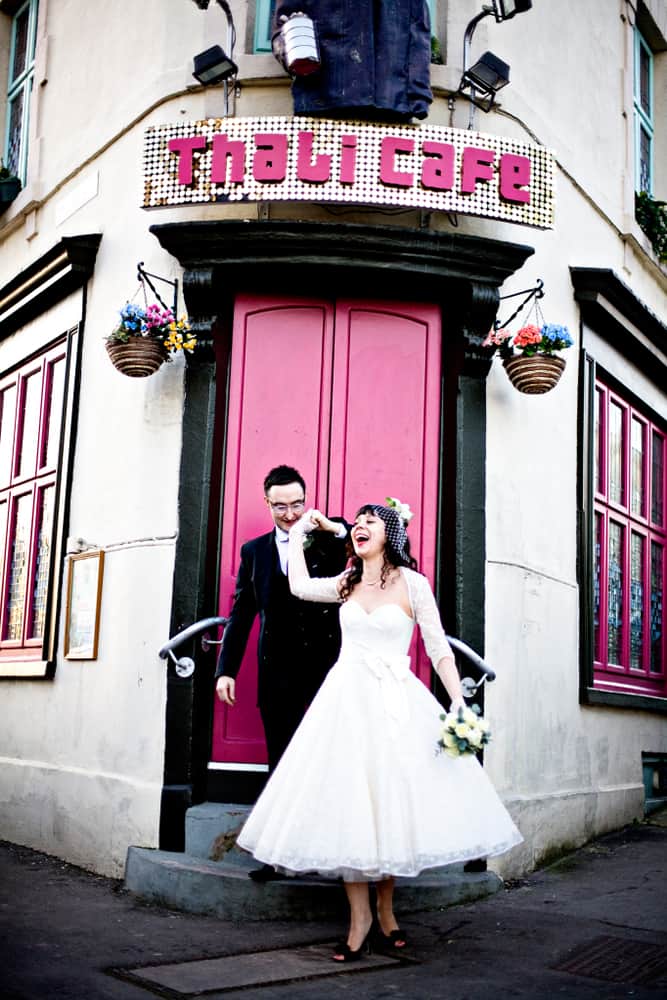 Bride and groom celebrating their wedding outside the Thali Cafe.
