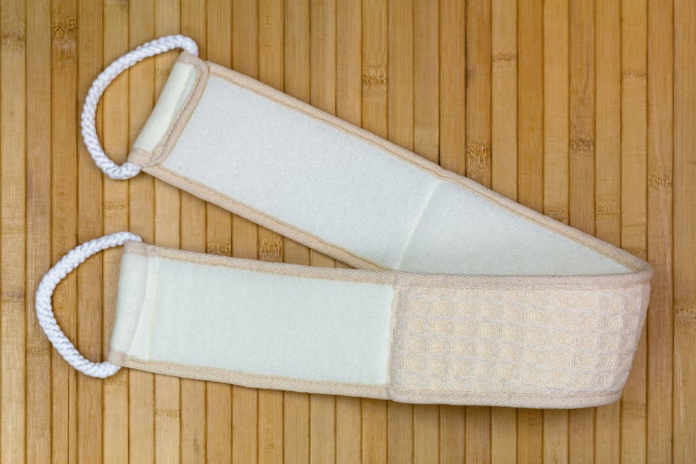 This is a close look at a fabric back scrubber with handles.