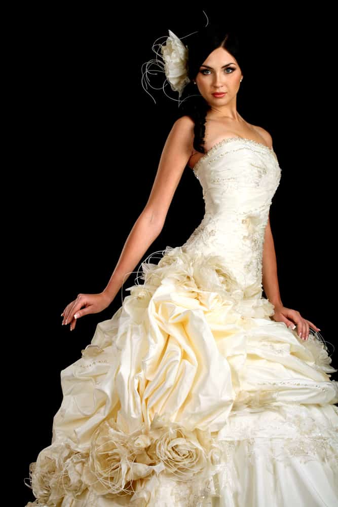 Bride wearing an intricate wedding gown with matching headdress.