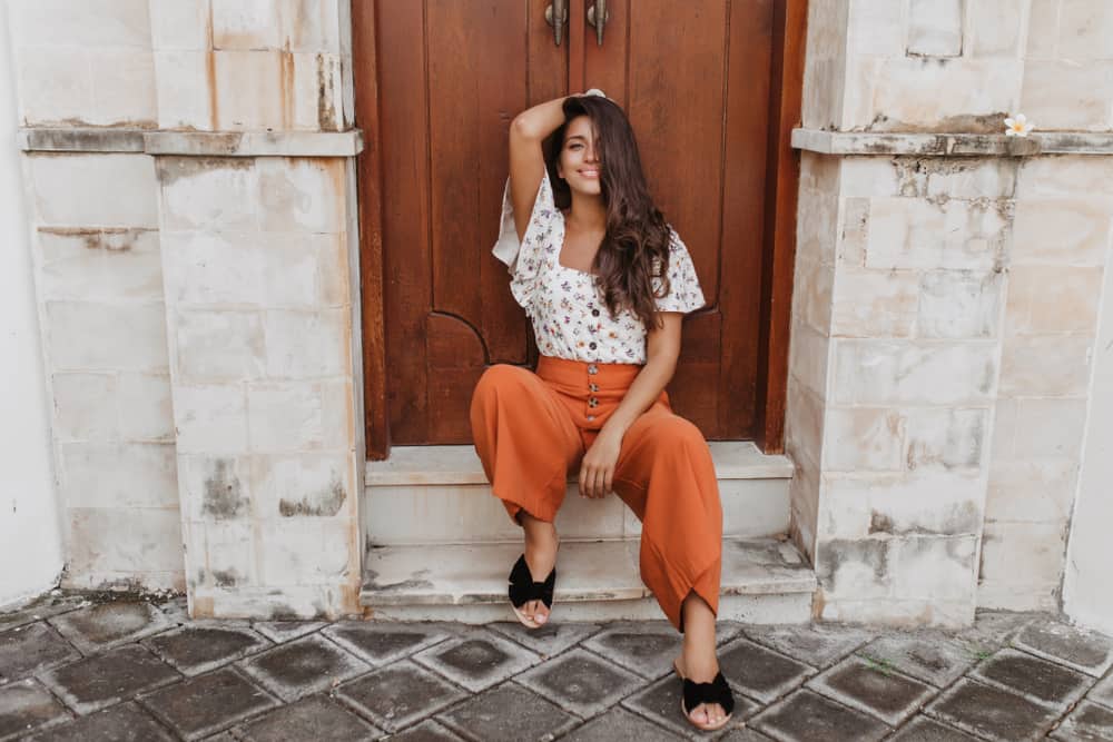 A woman wearing a pair of brown loose culottes.