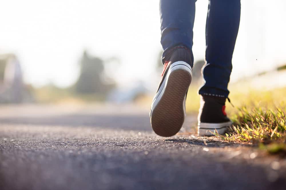 A close look at a woman wearing a pair of walking shoes.