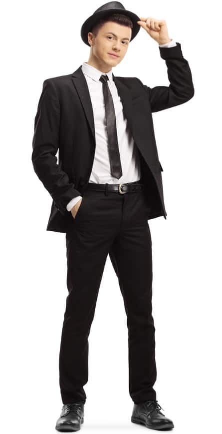 A man wearing a black suit and a matching black fedora.