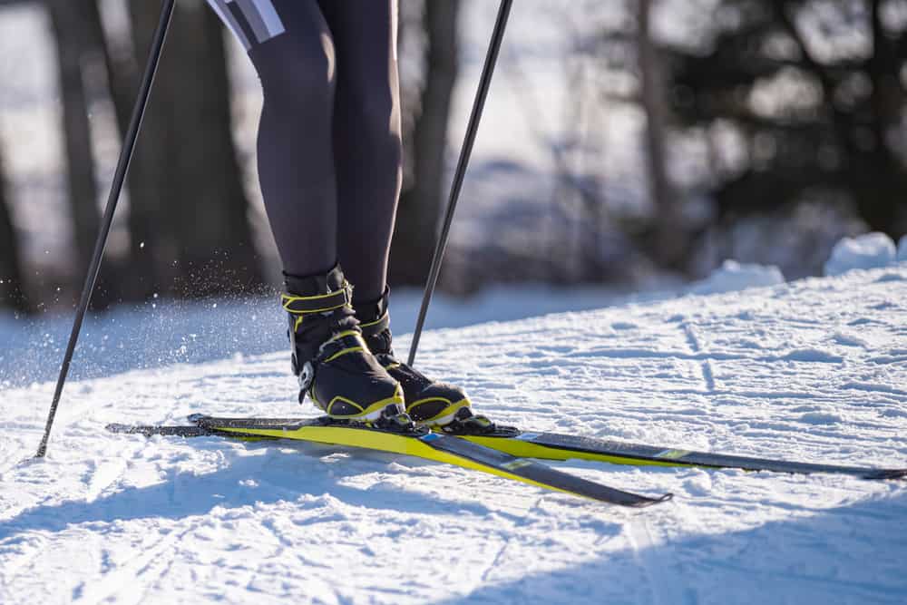 A close look at a skier wearing ski boots.