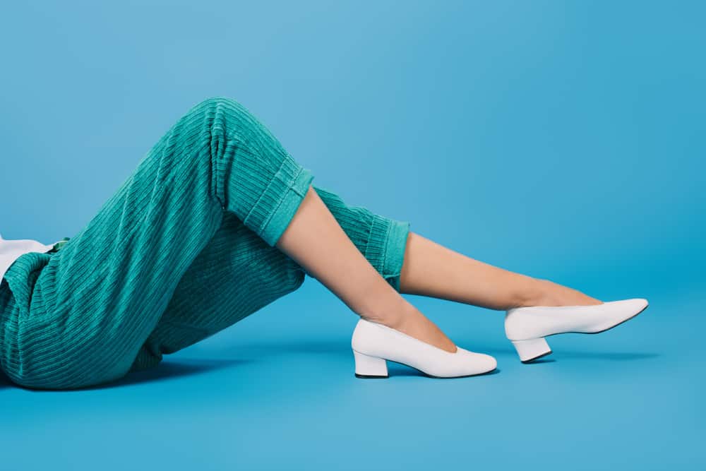 This is a close look at a woman wearing a pair of green cropped pants.