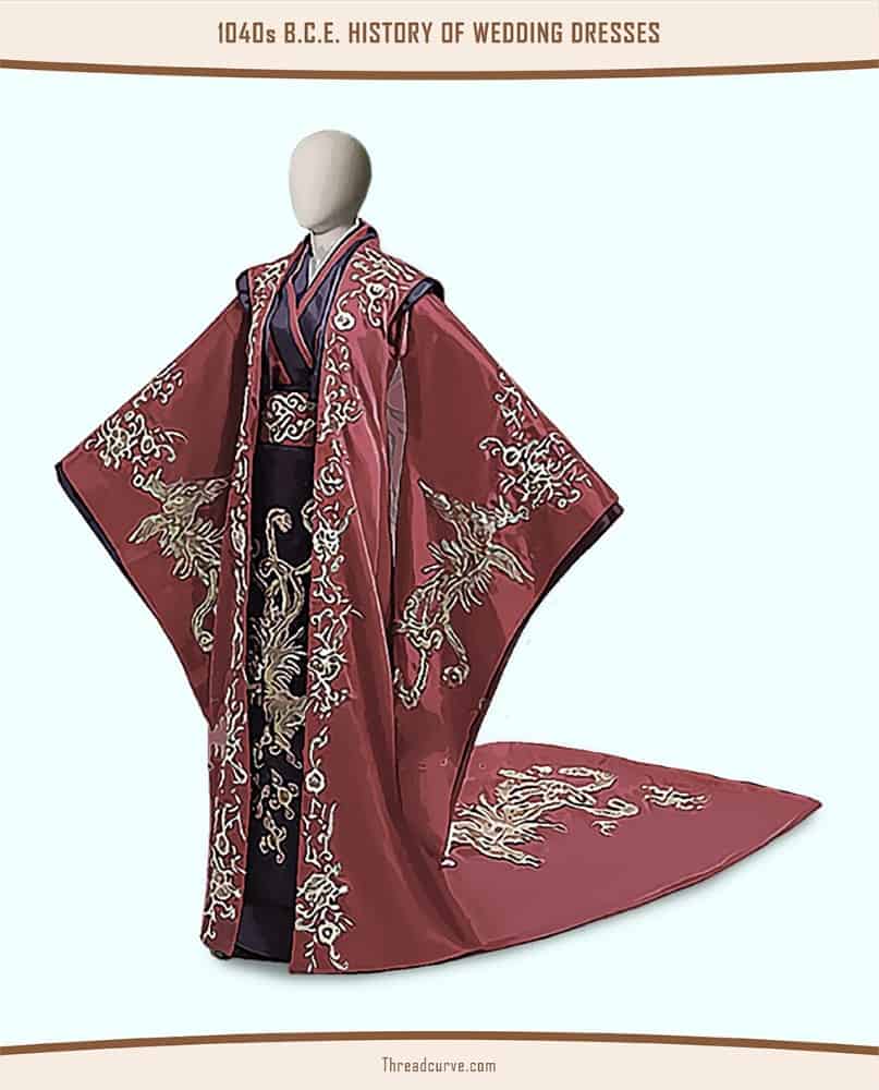 Mannequin wearing a black and red robe adorned with intricate embellishments.