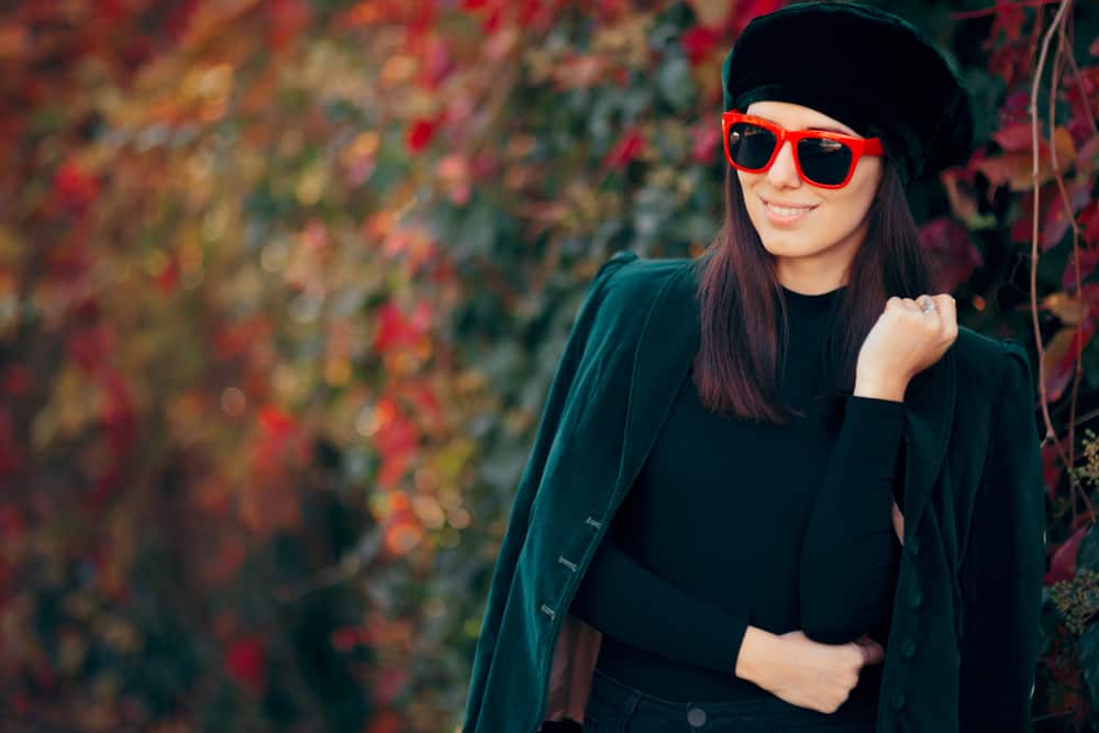 This is a woman wearing a green velvet beret to match her all-green outfit.